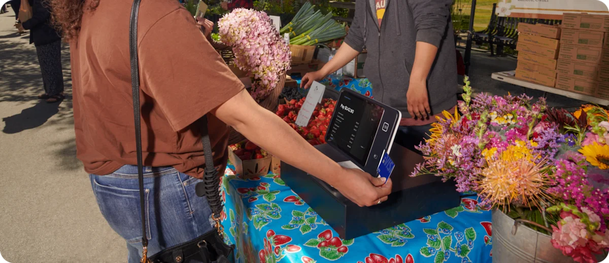 Square Stand in use at a flower stall at an outdoor market