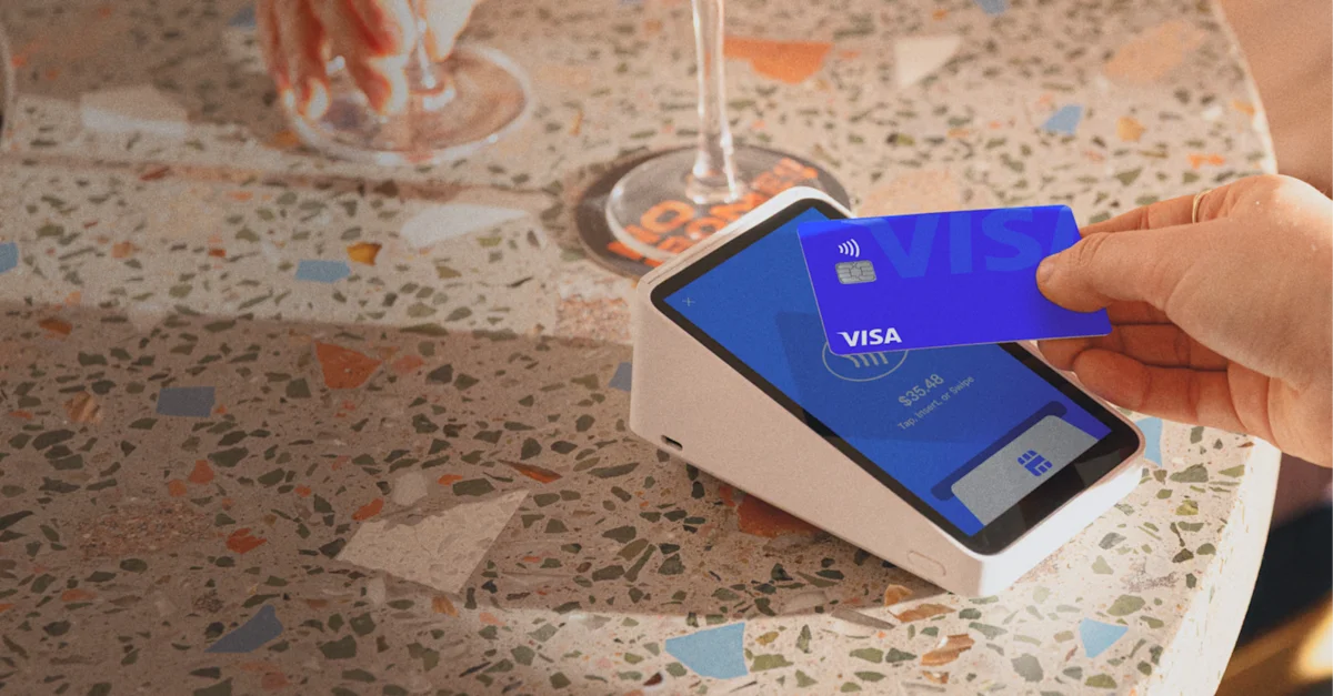 Square Terminal on a counter with a card being tapped